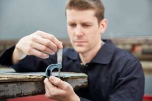 Engineer measuring using a micrometer